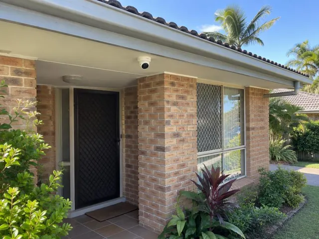 CCTV camera mounted under the eave on a brick home porch in Currumbin Waters